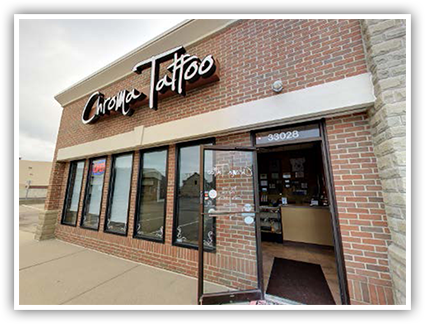Image of Chroma Tattoo storefront with a view of the interior through the open front door